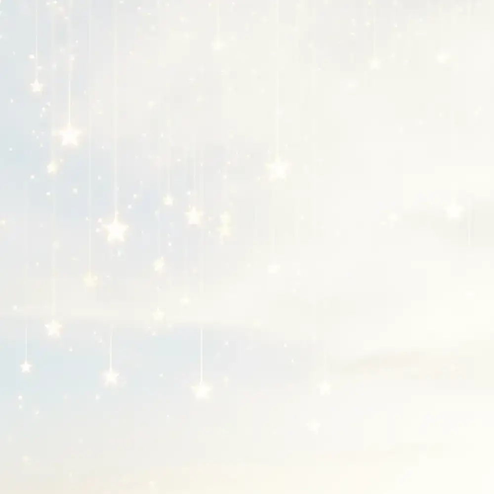 Golden glowing stars falling against a light background
